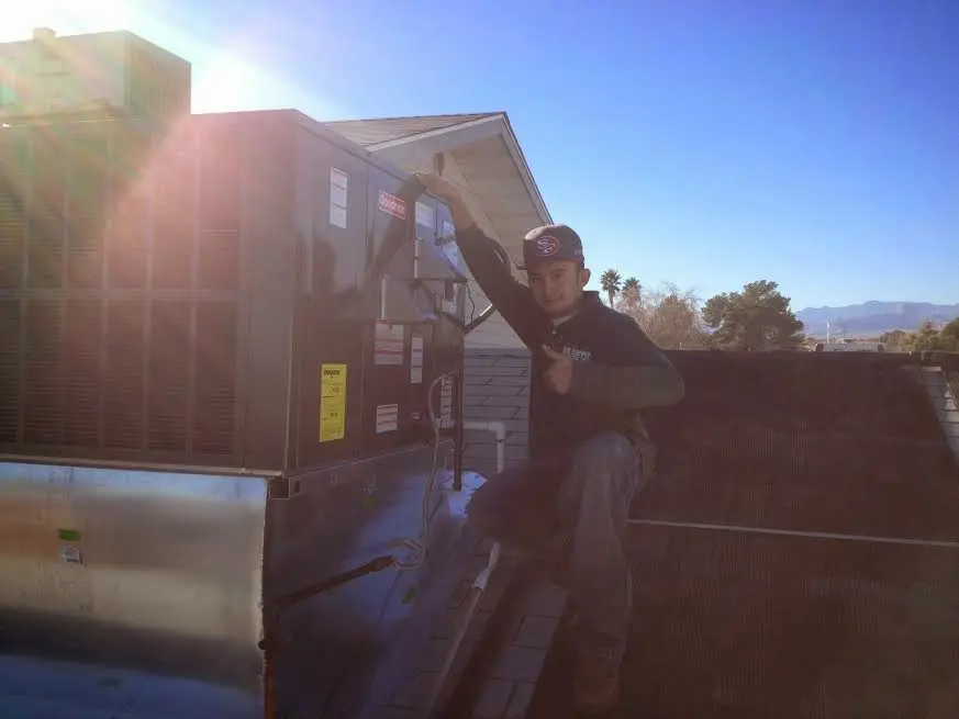 HVAC technician performing Boiler Repair on a rooftop unit in Sweden